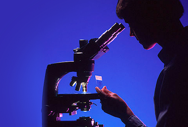 Pathologist with microscope